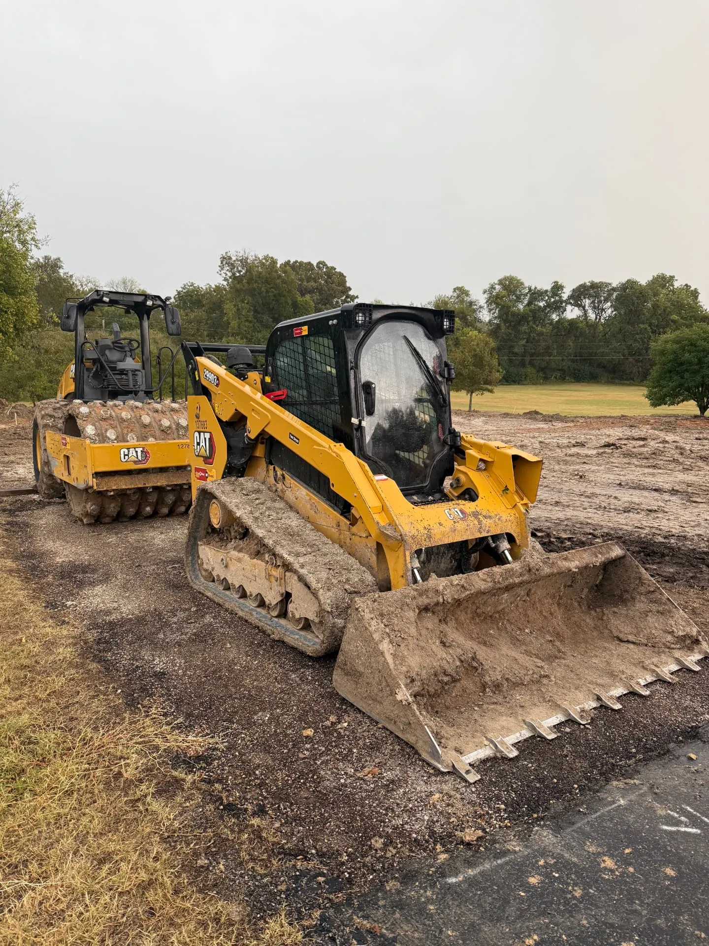 Driveway base being graded and shaped on a rural lot in North Texas